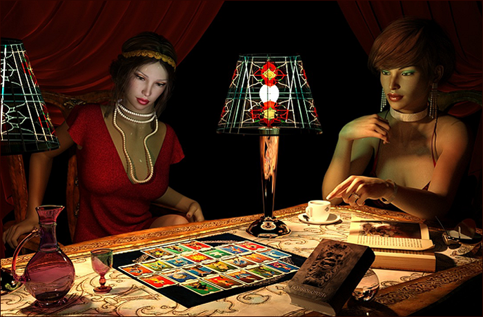 Two women sitting at a table with tarot cards, an ornate tablecloth, and decorative lamps, in a dimly lit room.